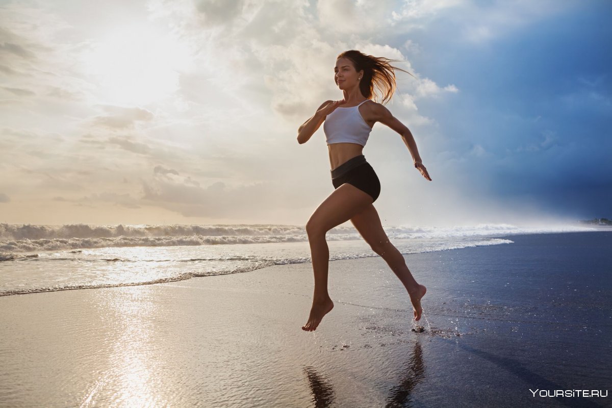 Девушка с длинными волосами на пробежке вдоль моря в Сочи