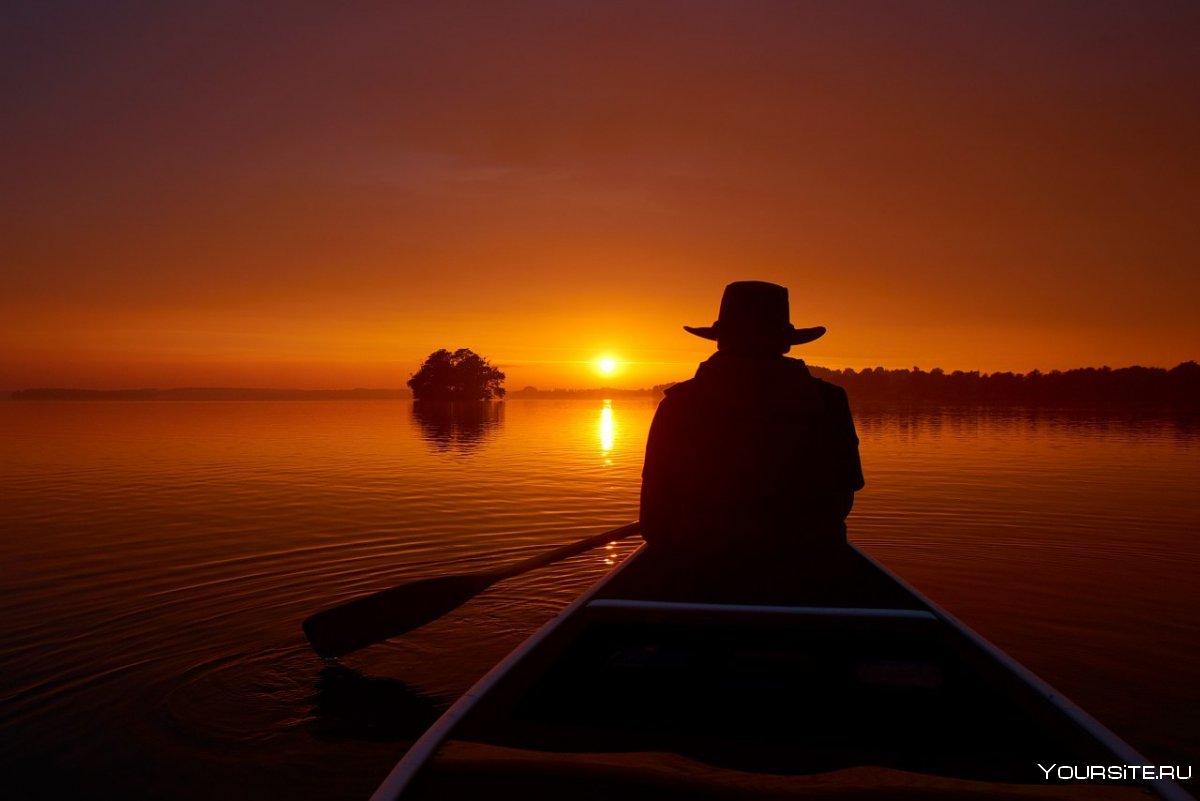 Человек в лодке на закате