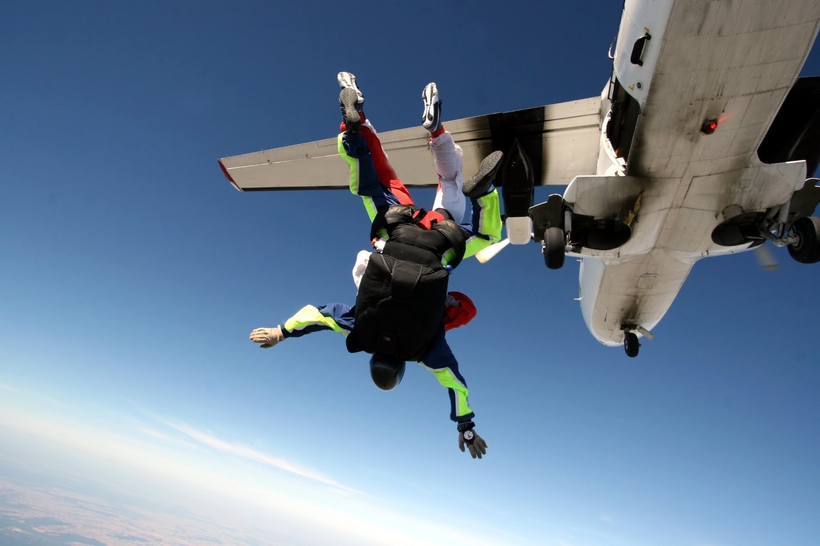 Спортсмен спускаясь на парашюте. Прыжок с самолета. Прыжок с парашютом. Самолёт для прыжков с парашютом. Прыжок с парашютом из самолета.